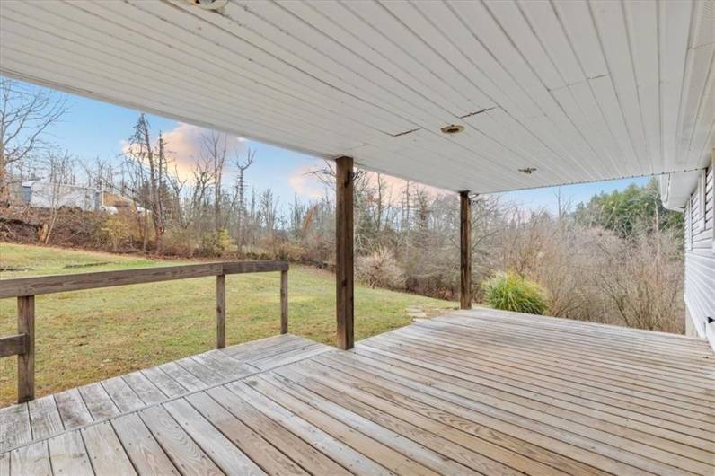 Private back yard off covered patio deck.