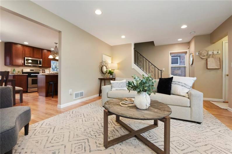 Layout from living room looking into open dining and kitchen area