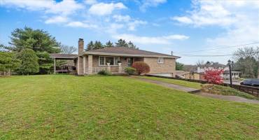 Large front yard with parking available on the side of the house