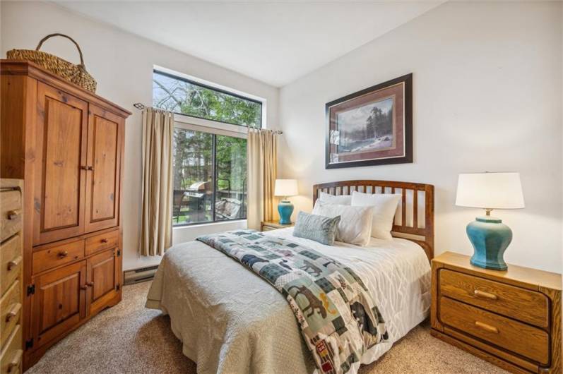 Bedroom #3 features a large picture window with views of the golf course and deck.