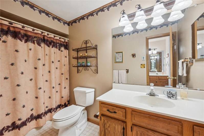 The en suite private bathroom  features a tub & shower, large vanity, and dressing area.