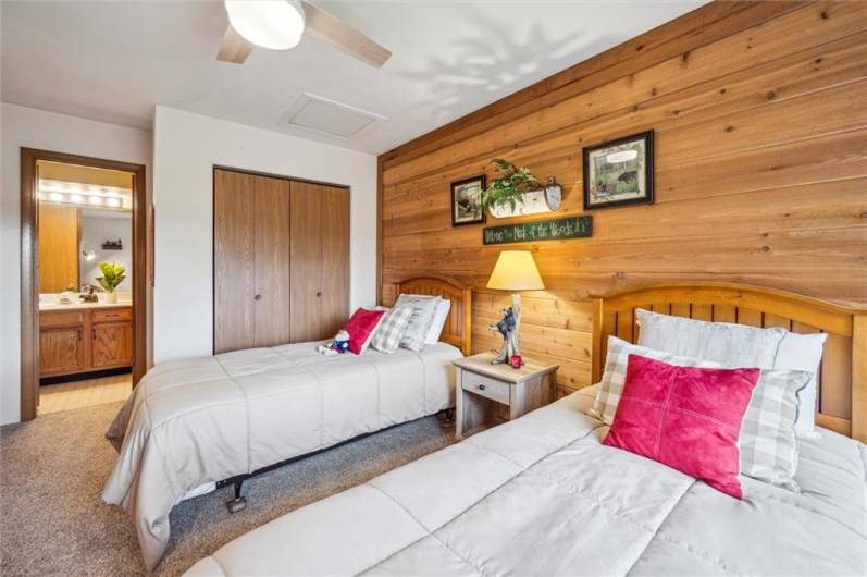 Bedroom #4 features a full bath with shower & tub, a large closet, and cedar plank accent wall.