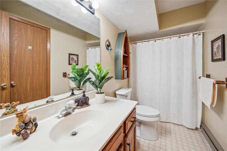 The upper level bathroom with shower & tub.A second large storage closet is next to the bathroom.