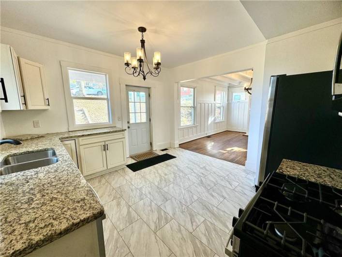 The kitchen and dining room are a huge well lit space and also have access to the rear covered porch and yard.