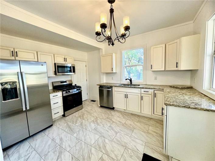 The kitchen is spacious, has plenty of natural light, and ALL Brand NEW Stainless Appliances, Granite and plenty of cabinet space.