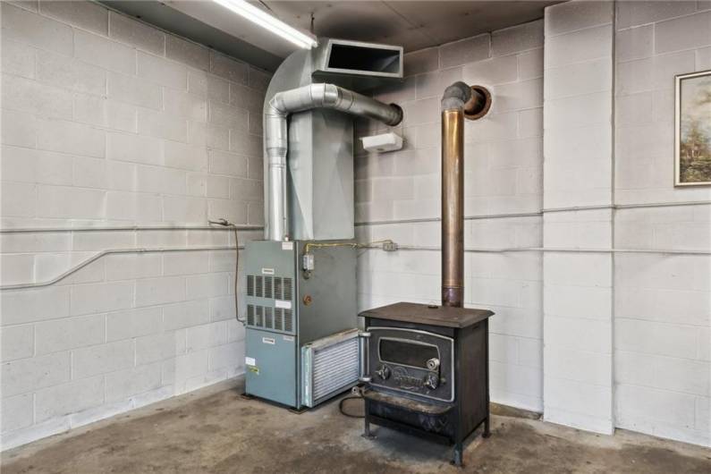 WOOD AND OIL FURNACE IN GARAGE