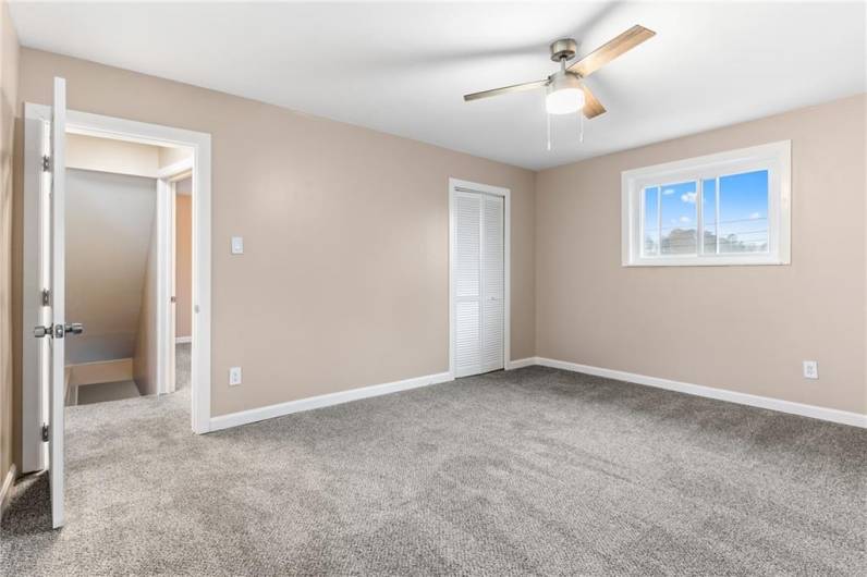 Bedroom 1 - With a window in the front and back, and a ceiling fan, you can save on utilities in the Spring and Fall by enjoying a refreshing cross breeze!