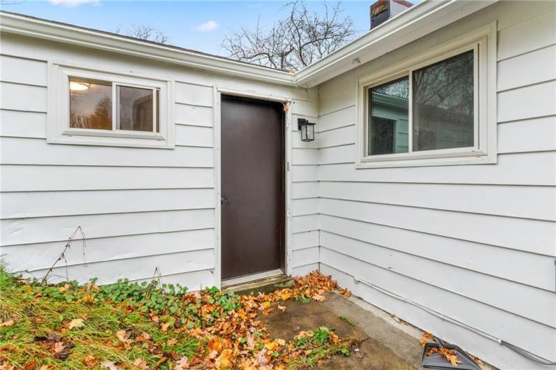 A rear door offers direct access to the backyard