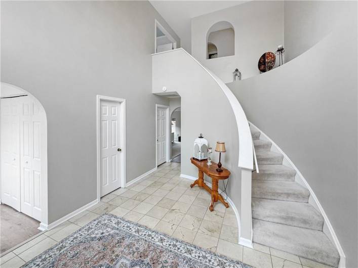 Impressive foyer with curved staircase.