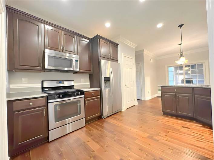 This spacious Eat-In Kitchen is 25’x12’ with hand scraped solid ¾” oak floors, two-piece crown molding and lots of recessed downlighting.