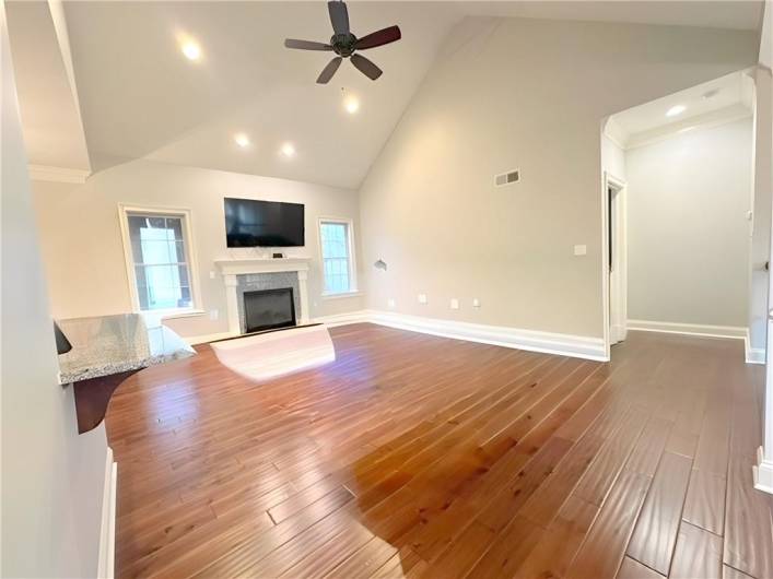 VIRTUALLY STAGED this view of the Family Room looks towards the fireplace and out to the enclosed Three Season Patio.