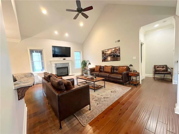 VIRTUALLY STAGED Family Room on the main Level to show another way to furnish the 20'x14' space. To the far left is the Master Bedroom Suite.