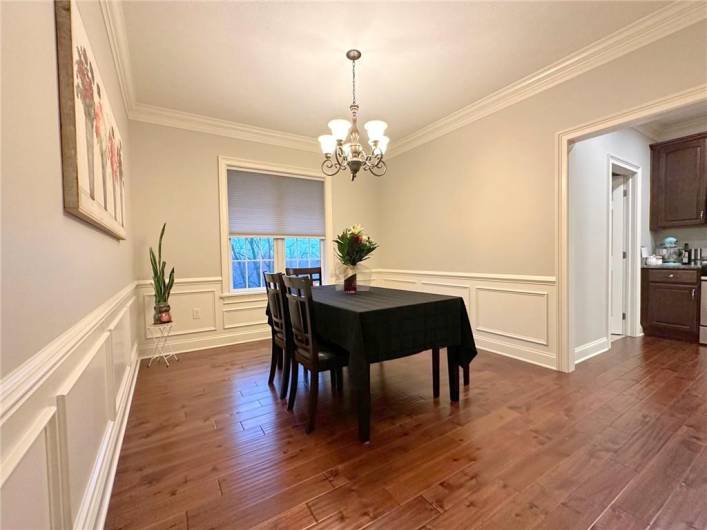 The Dining Room is elegant with double crown molding and picture box waiscoting. The hand scraped solid oak flooring flows through the main level.