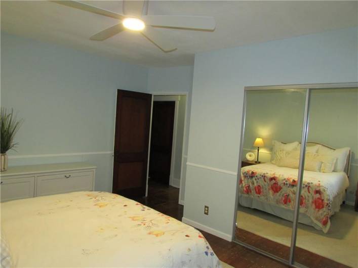 Large primary bedroom with new ceiling fan and huge walk-in closet