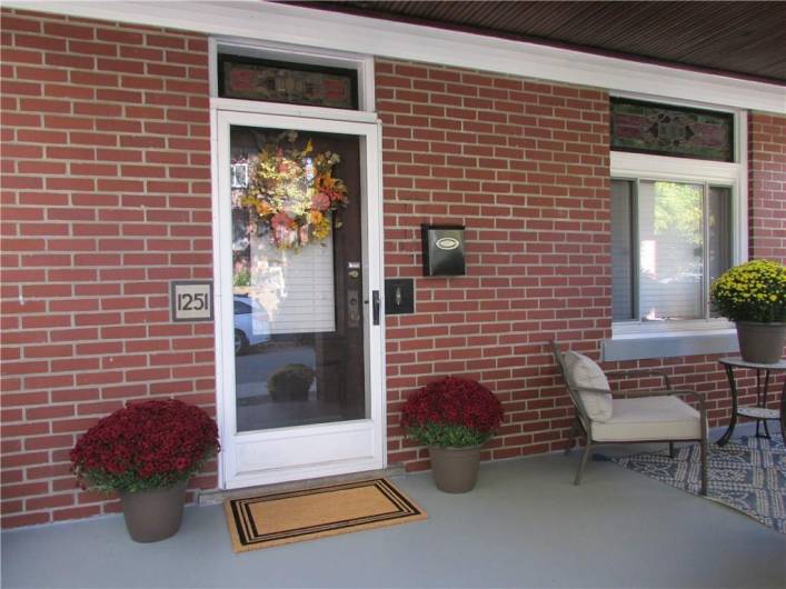 Gorgeous, vintage stained glass transom windows over entry door and over front window in dining room.