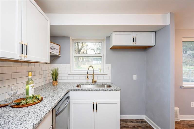 Love the granite countertop and the oversized inlay sink with a sprayer faucet.