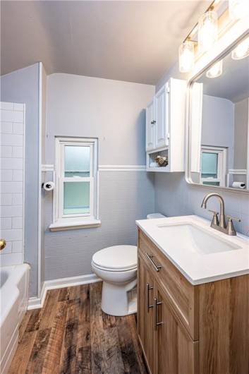 Love the new floor, vanity, double flush toilet, mirror, lights and fixtures.