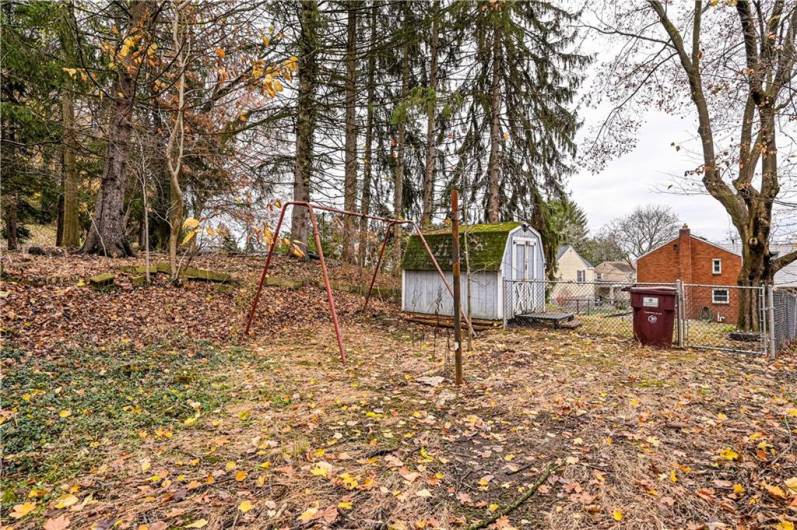 Beyond the fence is more yard area bordered by trees. A great area for a bonfire, cornhole, horseshoes and playground area.