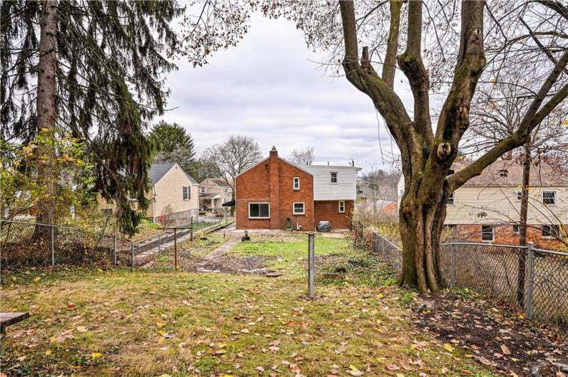 A view of the lovely fenced in back yard.