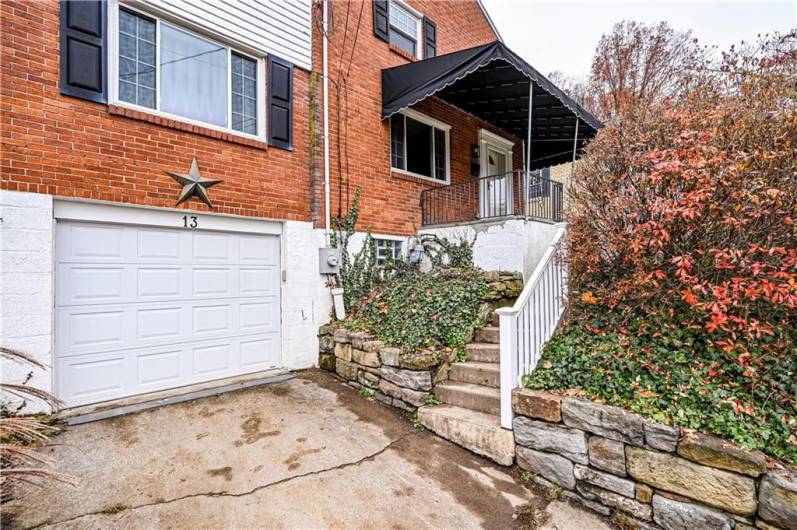 There is a cement driveway, keyless entry pad and updated stone wall (2013).