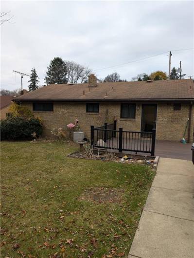 Level back yard with easy access to public street