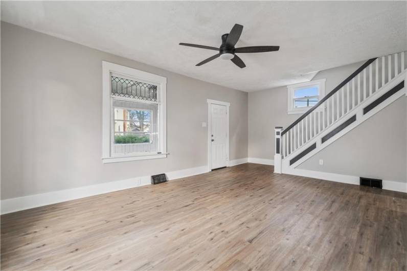 Original window and ornate staircase showcase the original charm in this home.