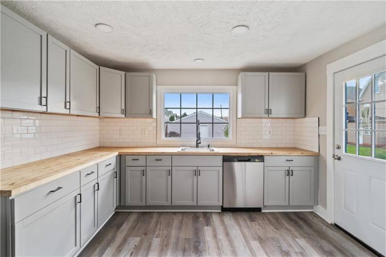 Brand new kitchen with new cabinetry and butcher block countertops.