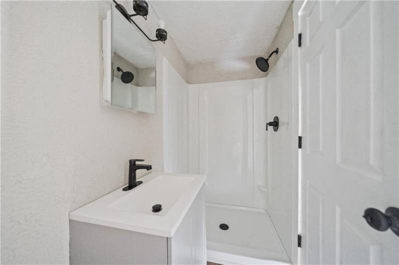 The first floor on suite boasts a walk in shower & modern matte black fixtures.