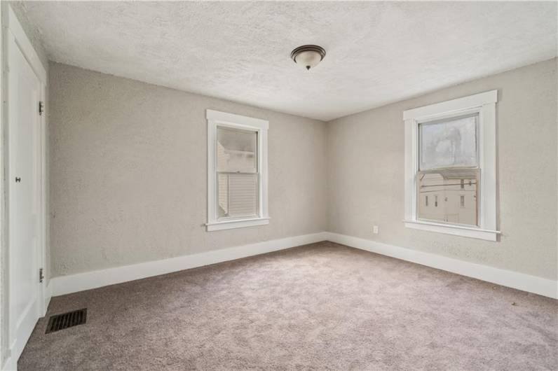 Additional bedroom is a great size with new carpet, paint, & light fixtures.