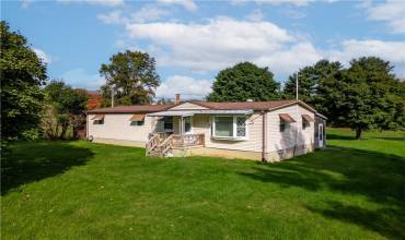 Experience the perfect blend of rustic charm and cozy living in this manufactured ranch home, a perfect compliment to the natural beauty of its nearly 2-acre setting.