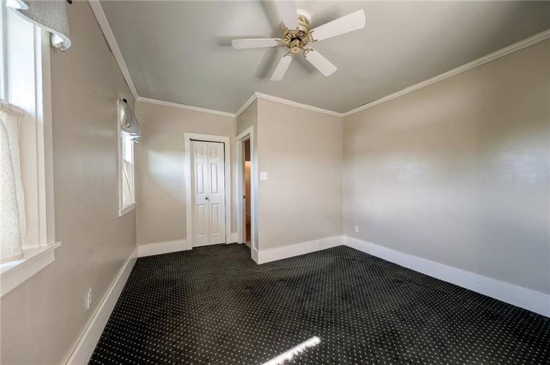 Third bedroom with carpeting and ceiling fan.