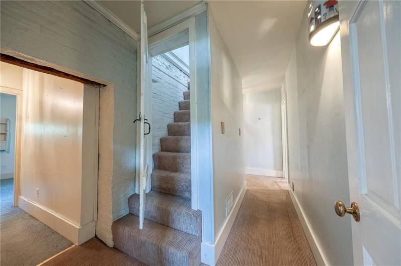 The stairs lead to the fourth bedroom which is the entire upper floor! There skylights making is bright and airy. Plenty of room for storage.  It would make a lovely den, art studio, game room, or bedroom .