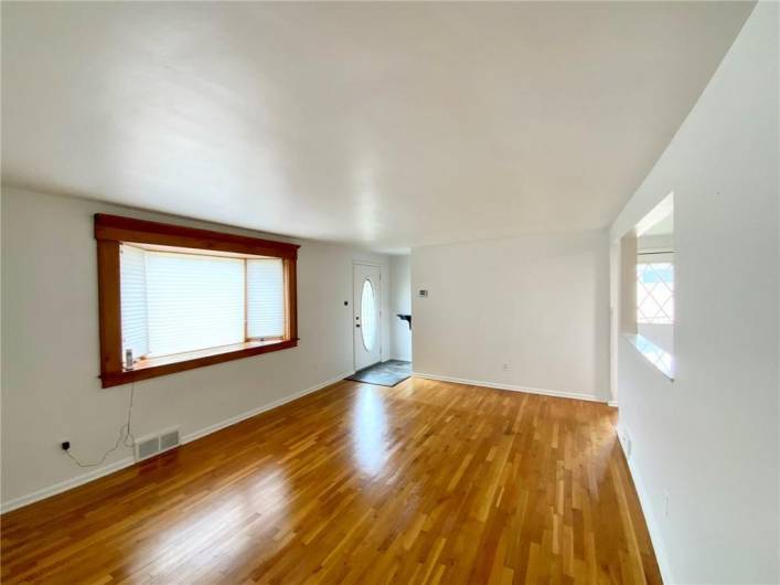 Living Room with Gleaming Hard Wood Floors and Bay Window.