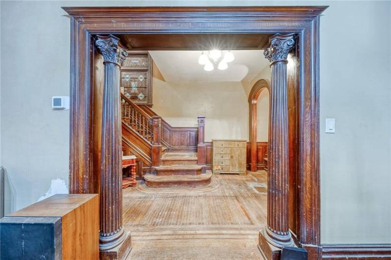 VIEW INTO THE ENTRY HALL.  NOTE THE STAINED GLASS WINDOW IN THE STAIRCASE.