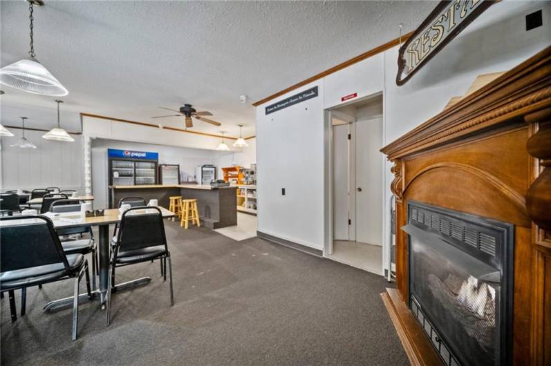 Closer view of 2nd half dining room to show space between the fireplace, entry to bathrooms and serving island.