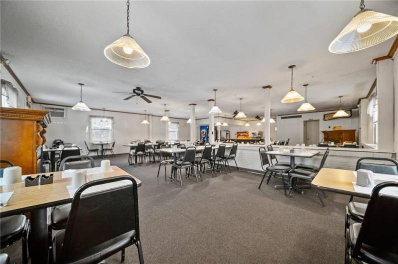 View of dining room from front right side toward kitchen area.