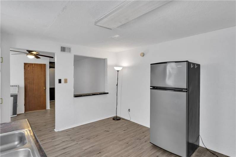 Eat in Area of the Kitchen Next to Refrigerator With Pass Through. Wood Door in LR/DR Opens to Full Bath.