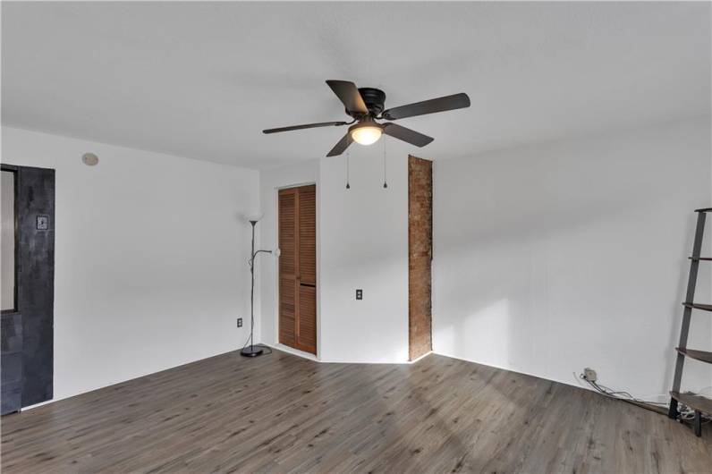 Upper Level Bedroom or Living Room with Newer Wood-Look Floors and Ceiling Fan.