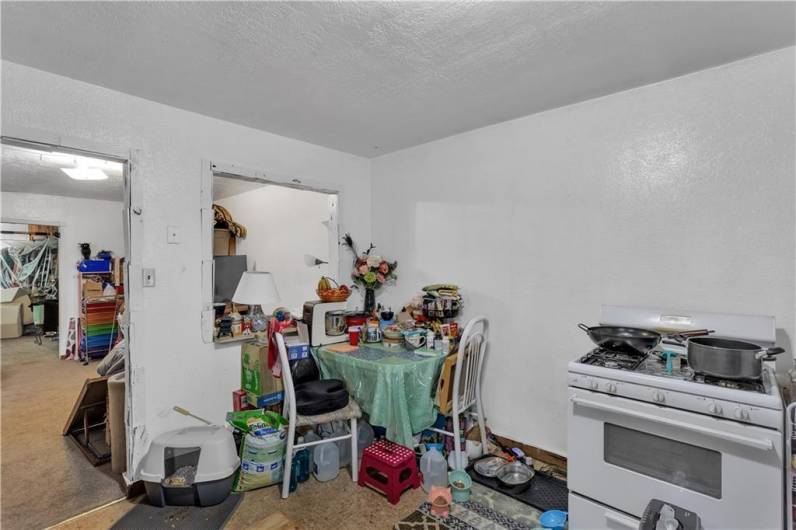 First Floor Unit Eat in Kitchen. Mirror Image of the Unit Above, With Pass-Through Into Living Room.