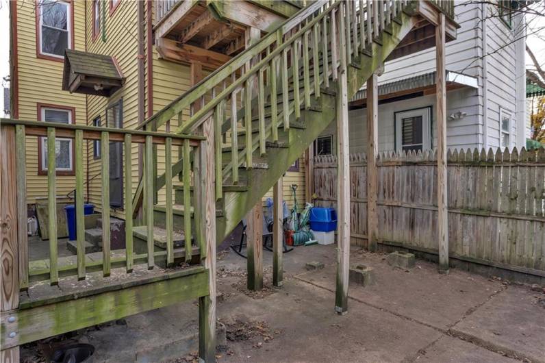 View from Patio of the First Floor Entry and Steps to Deck and Kitchen Entry to the Upper Unit.