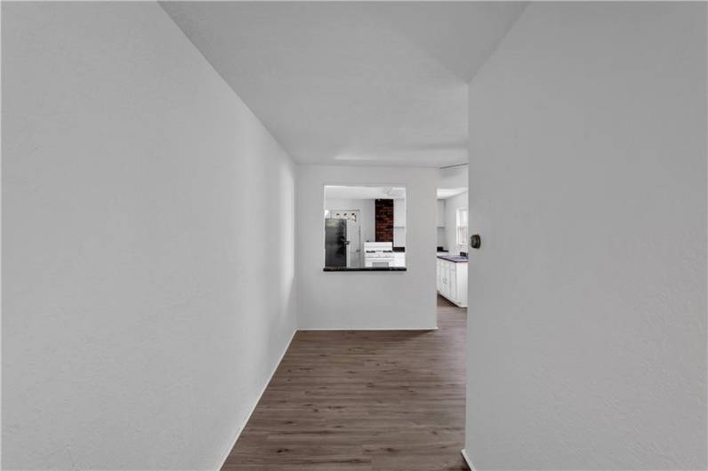 Hallway / Entry into Upper Level Unit at Top of the Stairs Opens into Dining/Living Room.