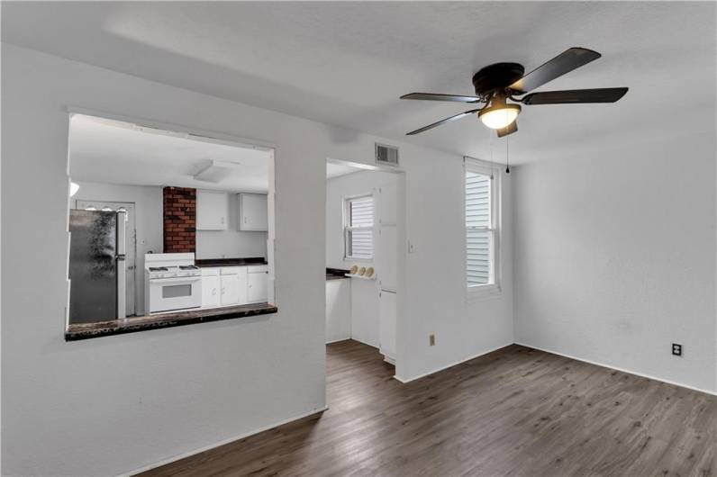 Dining or Living Room with Ceiling Fan. Open with Pass-Through to Kitchen.