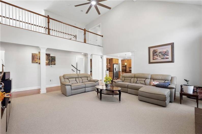 The Great Room is cozy with a stone fireplace and a 2-stroy vaulted ceiling.