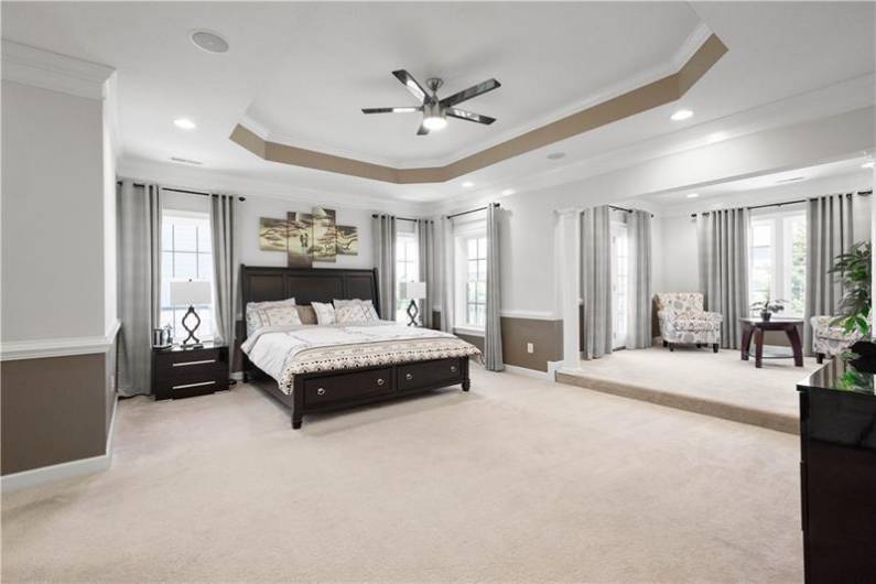 Impressive Owner's Suite with dramatic tray ceiling, sitting area with access to a private deck.