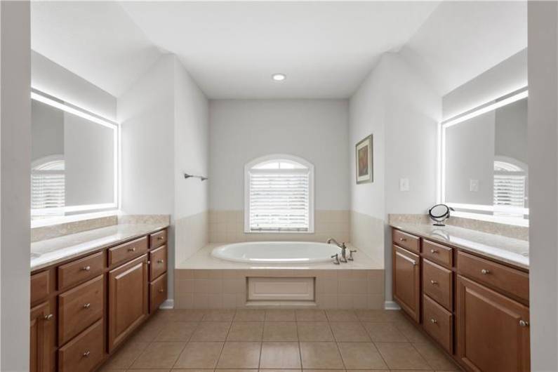 Owner's Suite with Dual Vanities, Soaking Tub, Tile Shower & Private Water Closet.