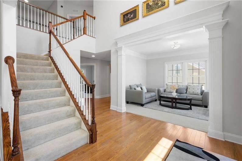 You are greeted with hardwood floors and tons of natural light in the grand 2-story foyer.