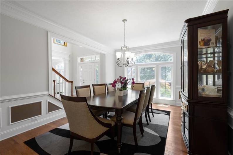 The Dining Room is large for hosting friends and family with custom wainscoting.