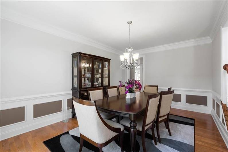 The Dining Room is large for hosting friends and family with custom wainscoting.