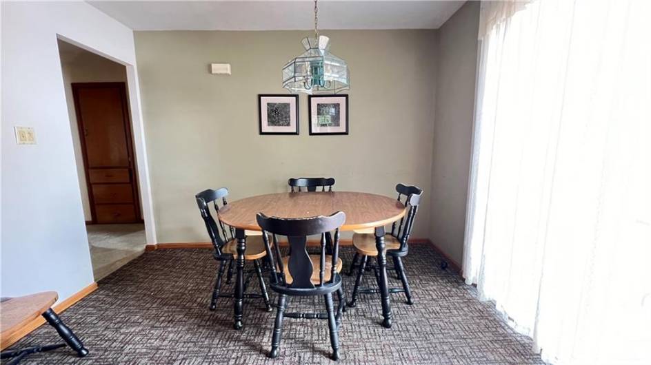 The dining area is off the kitchen with a patio door that flows out to the deck