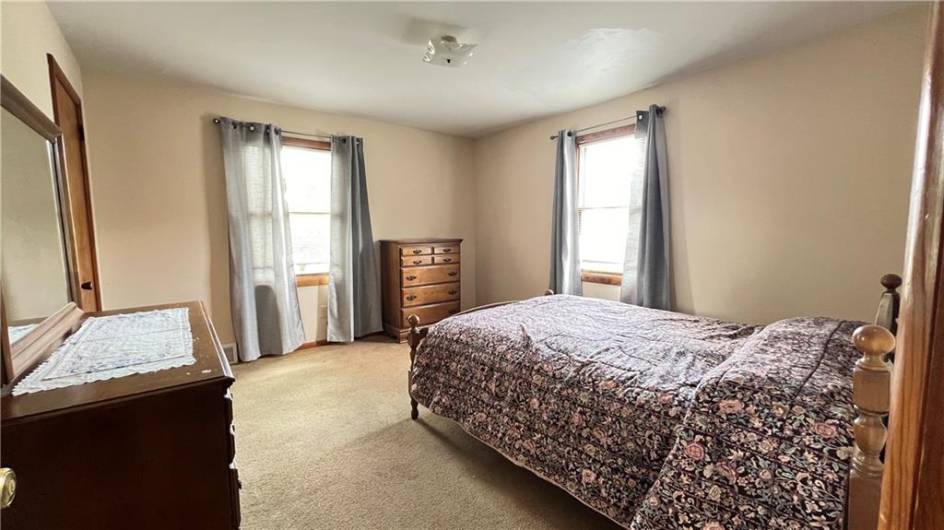 This is a large spacious room with hardwoods under the carpet and plenty of natural light